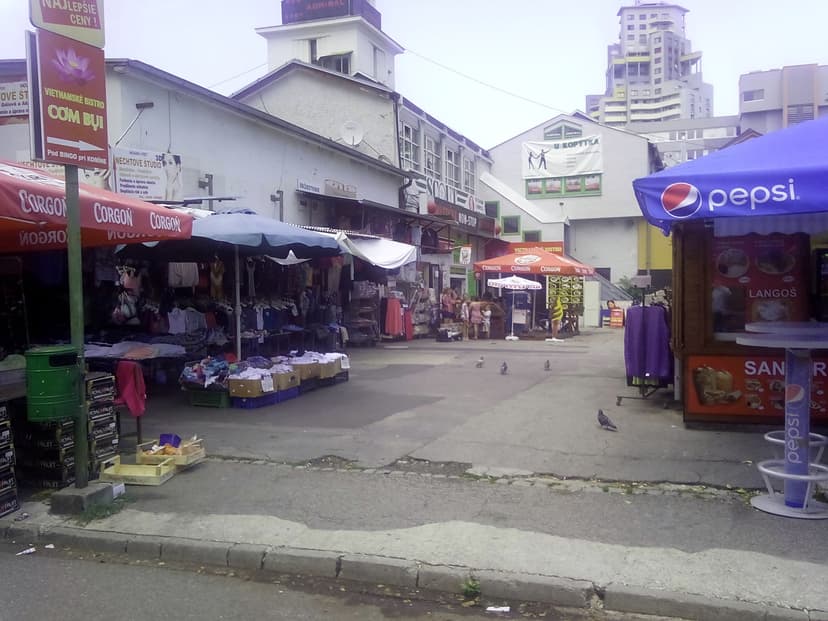 open-air market in Bratislava — market stalls with awnings and Slovak signs