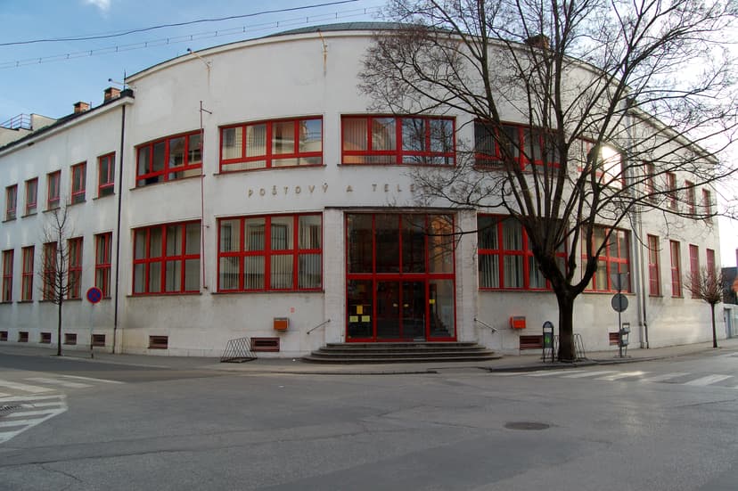 post office building in a Slovak town with the inscription “Poštový a telegrafný úrad” on the facade