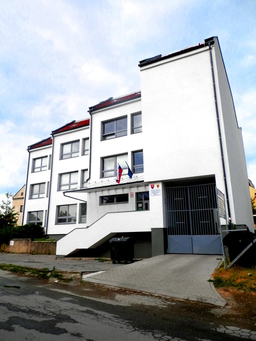building of the tax office in Prešov with a sign “Daňový úrad” and Slovak and European flags near the entrance